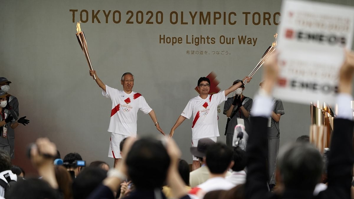 Tokyo's torchbearers pose during a lighting ceremony in Tokyo. Credit: Reuters Photo