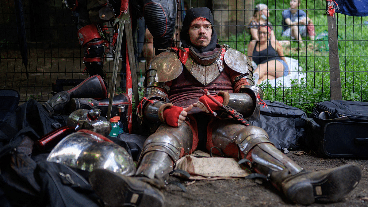 A member of the 'Gladiators NYC' armored combat group rests following a fight in Central Park, New York. Credit: AFP Photo