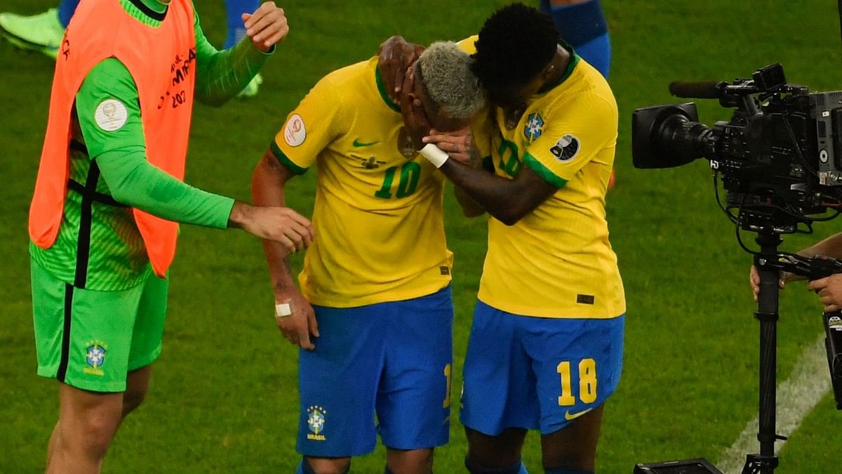 Neymar is comforted by Vinicius Junior in this photo. Credit: AFP Photo