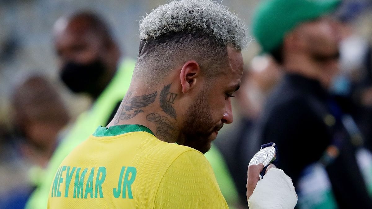 An emotional Neymar looks at his runners up medal. Credit: Reuters Photo