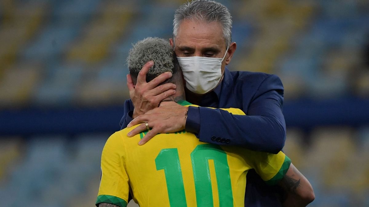 In this photo, Neymar is seen comforted by Brazil's coach Tite after their team's loss. Credit: AFP Photo
