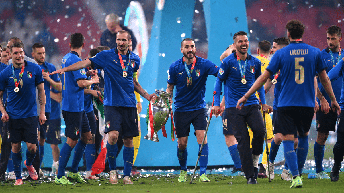 Italy's Giorgio Chiellini, Leonardo Bonucci and teammates celebrate with the trophy. Credit: Reuters Photo