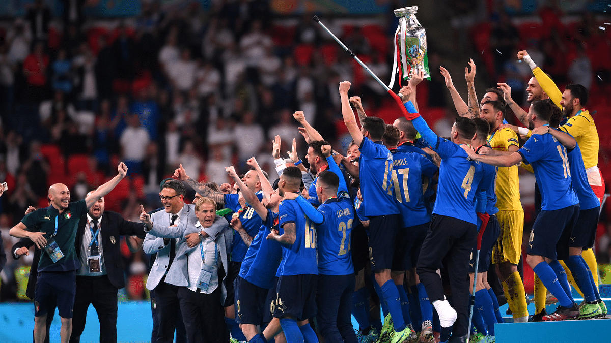 Italy players celebrate with the trophy. Credit: Reuters Photo