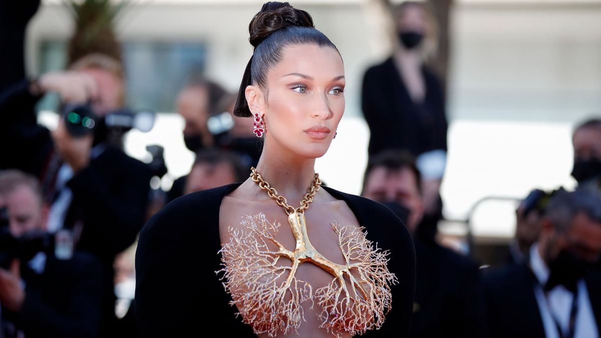 Supermodel Bella Hadid stunned all by walking the 2021 Cannes Film Festival red carpet in a black avant-garde gown paired with a ‘golden lungs’ necklace. Credit: Reuters Photo