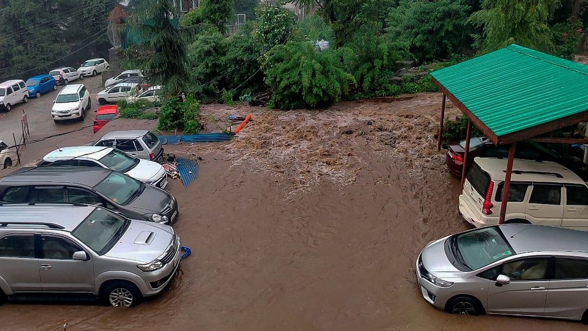Flash floods triggered by heavy rains swept away buildings and cars at tourist spots in Himachal Pradesh while bad weather also led to the closure of the airport in Dharamshala.