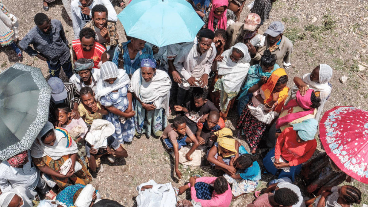 People wait to register during a food distribution organized by the Amhara government near the village of Baker, 50 kms South East of Humera, in the northern Tigray Region. Credit: AFP Photo