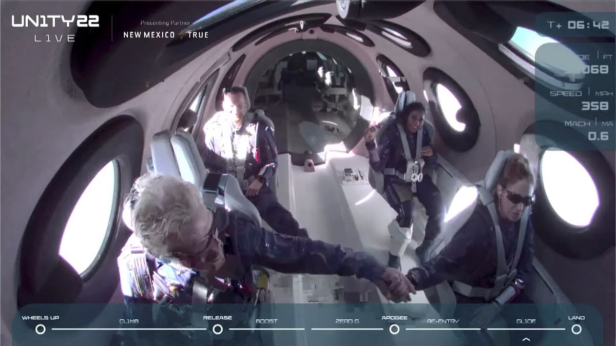 Richard Branson is seen congratulating the crew on board Virgin Galactic's passenger rocket plane VSS Unity after their ascent to the edge of space above Spaceport America near Truth or Consequences, New Mexico.