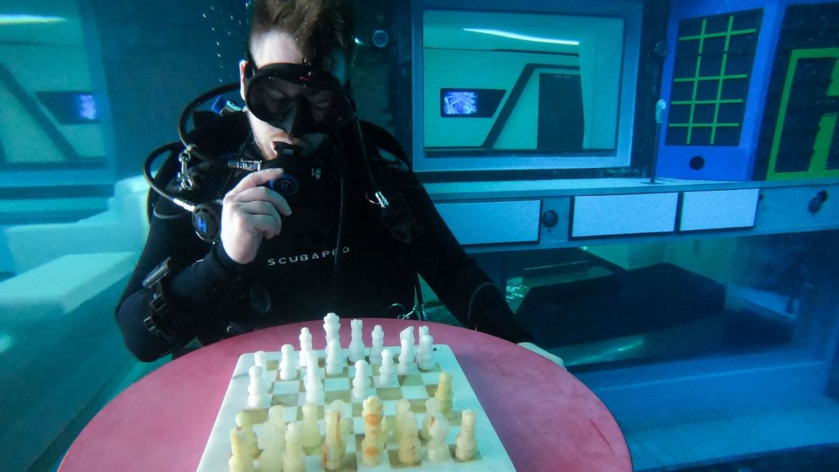 A diver plays mock chess at Deep Dive Dubai, the deepest swimming pool, in UAE. Credit: AFP Photo