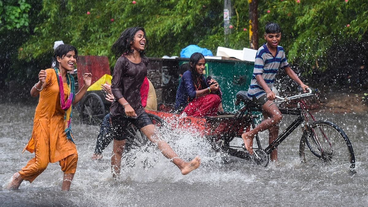 Children play in rain-water after a heavy monsoon shower in New Delhi.