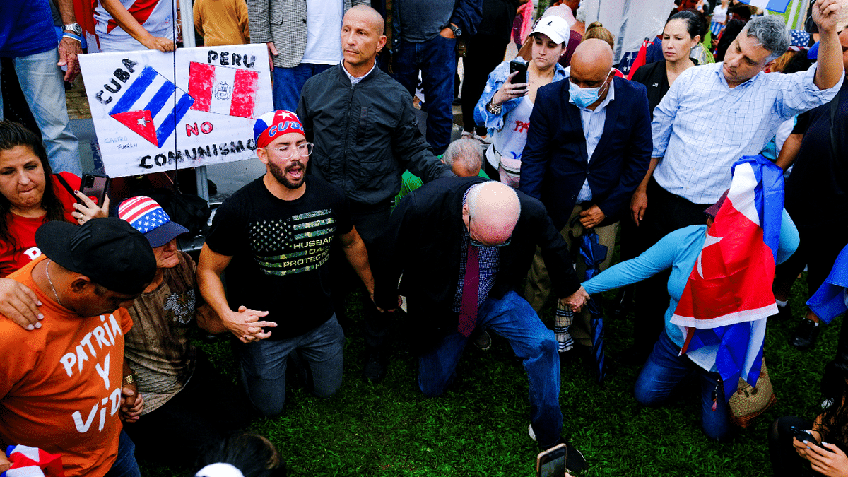 Emigres in the Little Havana neighborhood gather following reports of protests in Cuba against its deteriorating economy, in Miami. Credit: Reuters Photo