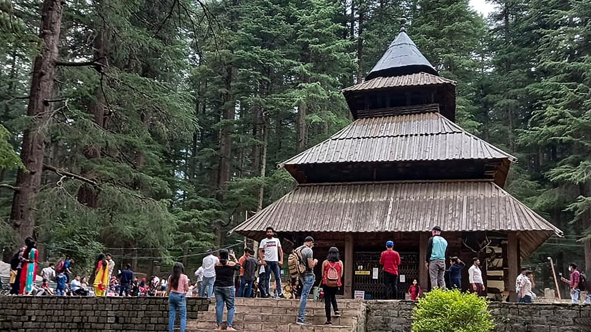 Not just tourist destinations, travellers also crowded religious places. Devotees throng Hidimba Devi Temple that was reopened after ease in Covid-19 lockdown, in Manali. Credit: PTI Photo