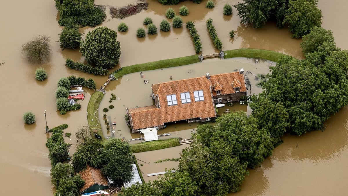 This aerial view taken in Valkenburg shows the houses inundated due to heavy rains. Credit: AFP Photo