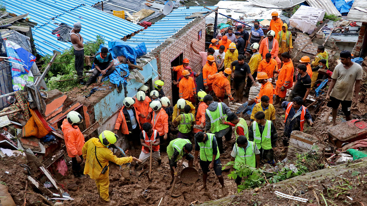 Rescue workers search for survivors after a residential house collapsed due to landslide caused by heavy rainfall in Mumbai. Credit: Reuters Photo