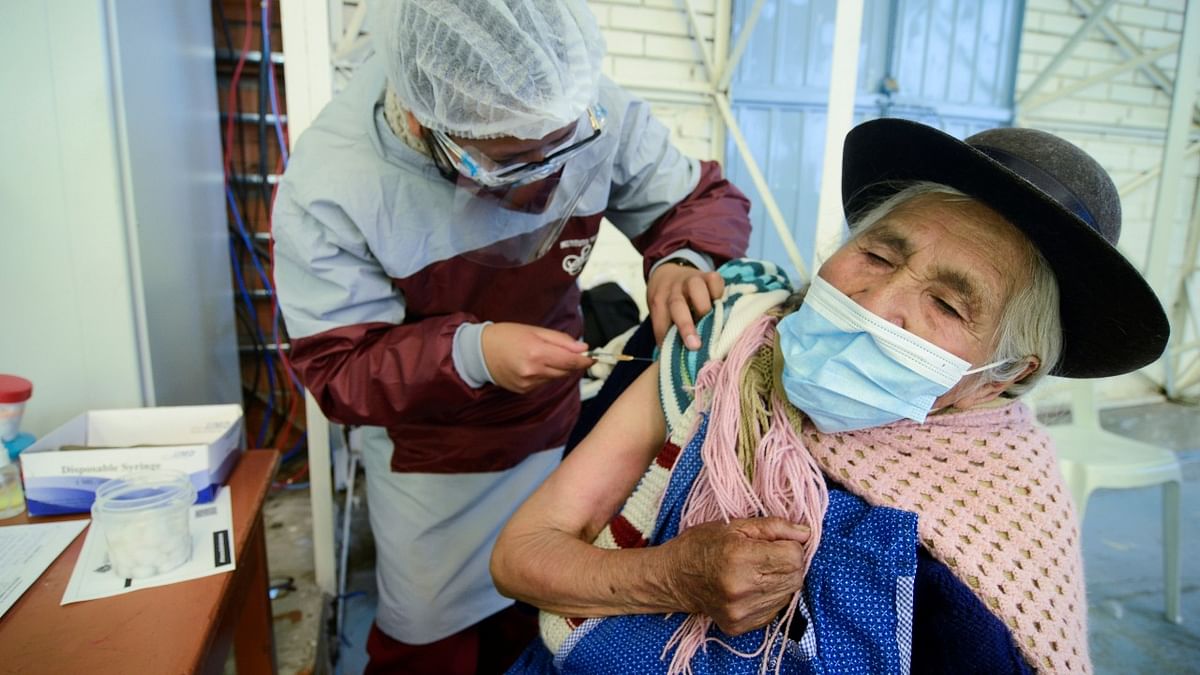 A woman receives a vaccine against Covid-19 at the Instituto Americano, in La Paz, Bolivia. Credit: Reuters Photo