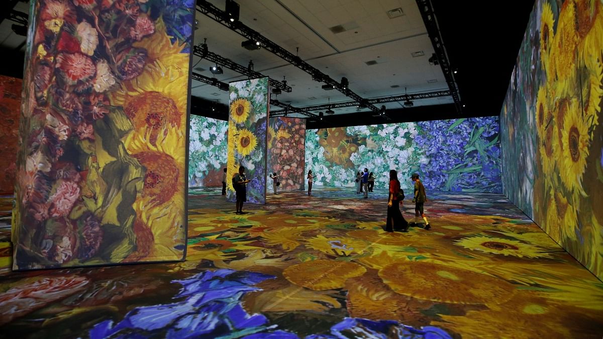 Guests walk through the exhibit Beyond Van Gogh: The Immersive Experience ahead of its opening to the general public at the Anaheim Convention Center in Anaheim, California. Credit: Reuters Photo
