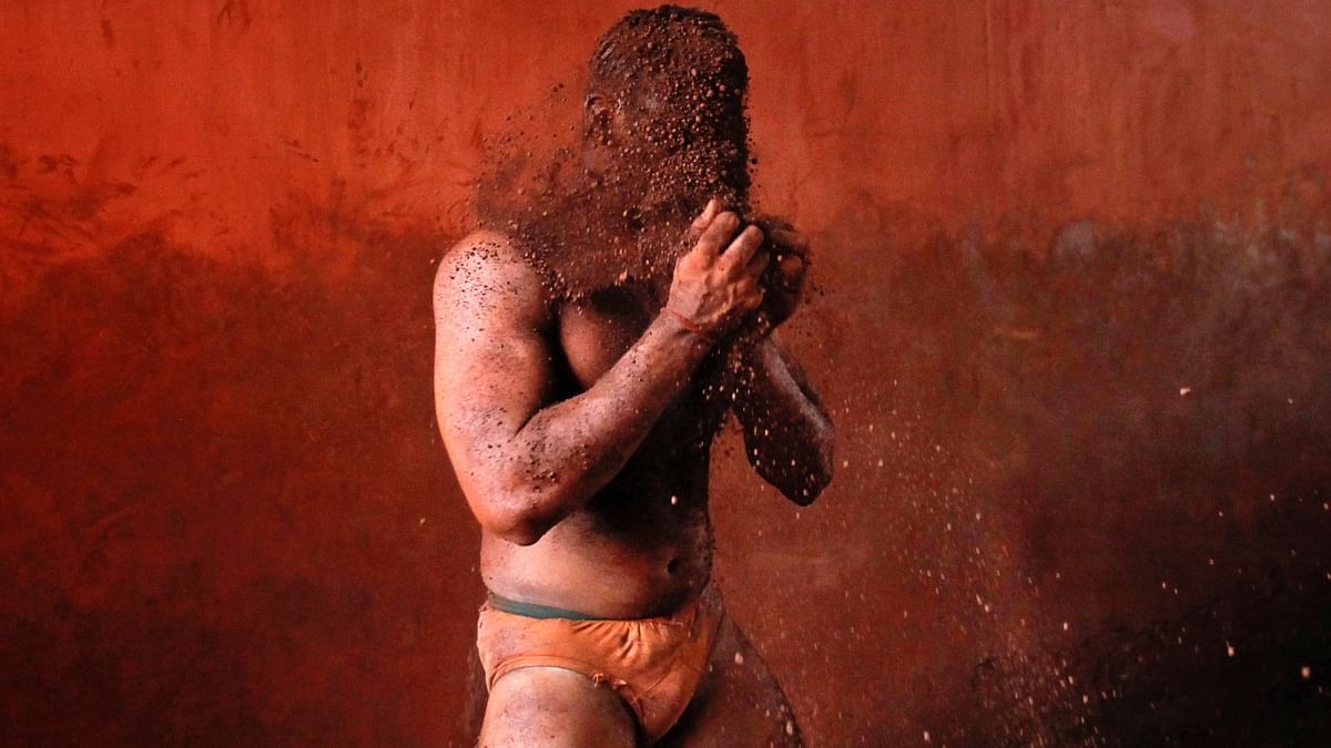 A wrestler rubs his hands with mud to prevent slipping due to sweat during a traditional mud wrestling bout at the Akhaara centre in Kolhapur. Credit: Reuters/ Danish Siddiqui
