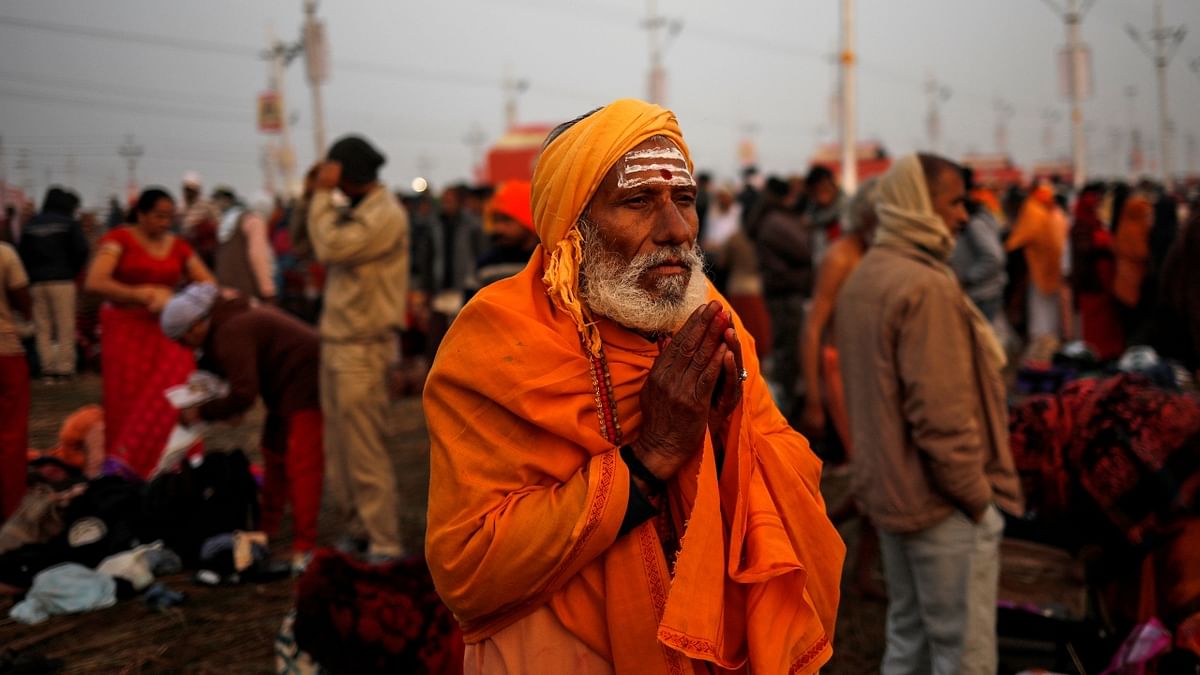 A devotee prays after taking a holy dip at Sangam during Kumbh Mela. Credit: Reuters/ Danish Siddiqui