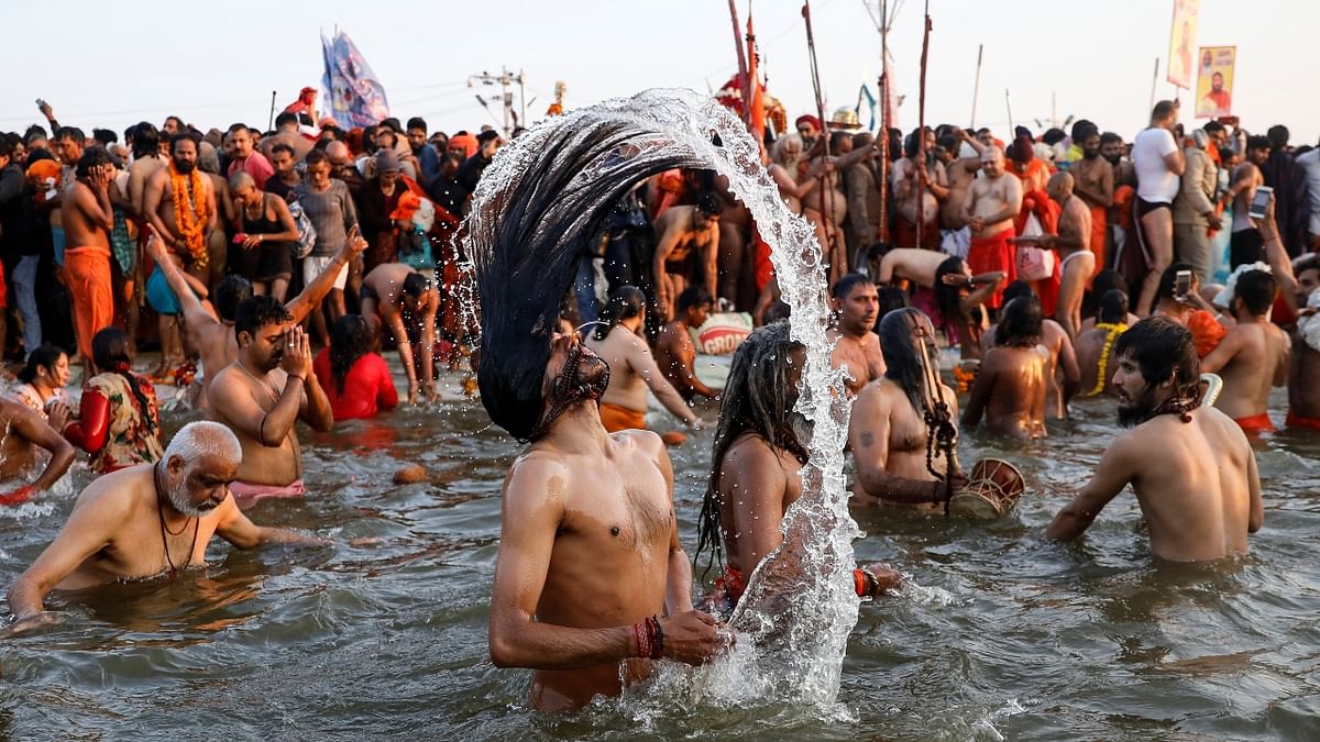 Naga Sadhus take a dip during the first Shahi Snan at Kumbh in Prayagraj. Credit: Reuters/ Danish Siddiqui
