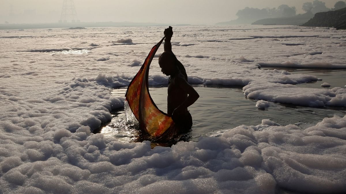 A devotee wraps his cloth after a ritual dip in the Yamuna river in New Delhi. Credit: Reuters/ Danish Siddiqui