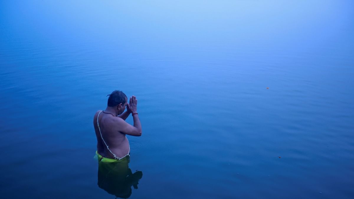 A Hindu devotee offers prayers to Sun in the waters of river Ganges in Varanasi, UP. Credit: Reuters/ Danish Siddiqui