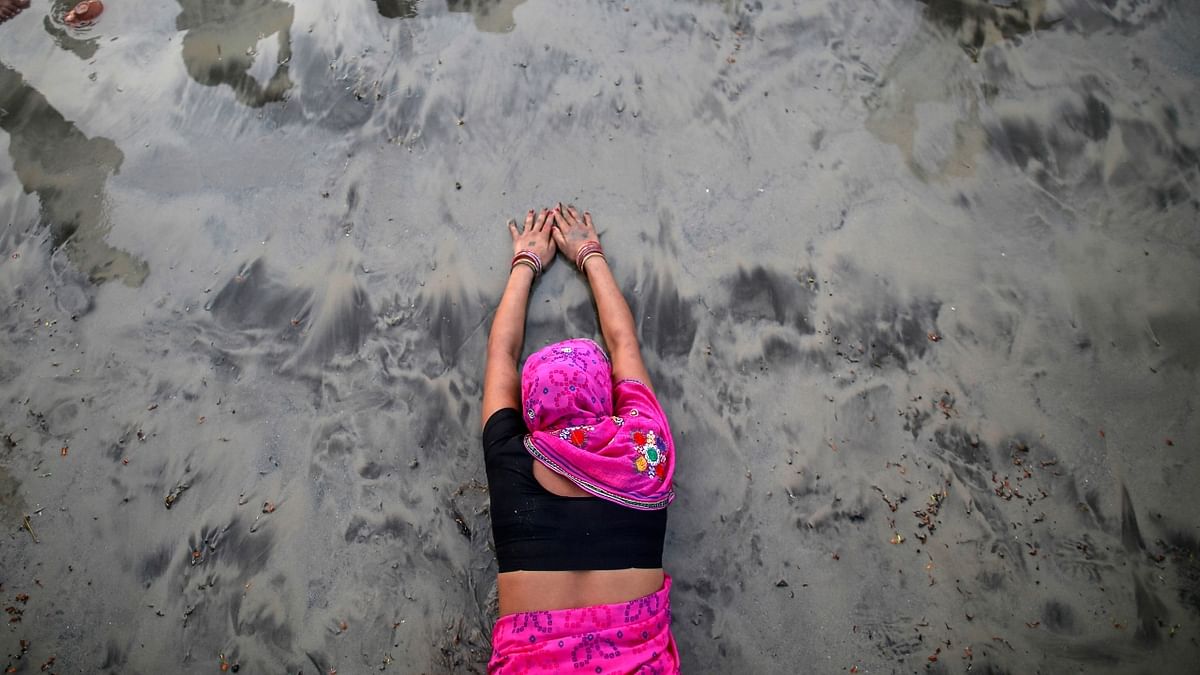 A Hindu devotee lies along the shores of the Sea as she offers prayers to the Sun in Mumbai. Credit: Reuters/ Danish Siddiqui