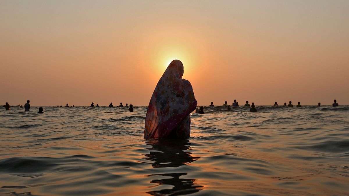 Devotees offer prayers in the waters of the Arabian Sea during Chhath Puja in Mumbai. Credit: Reuters/ Danish Siddiqui