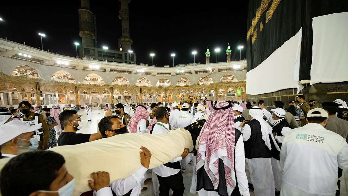 Small groups of pilgrims wearing masks have been circling the Kaaba - a stone structure that is the most sacred in Islam - as health professionals monitor their movements. Credit: Reuters Photo