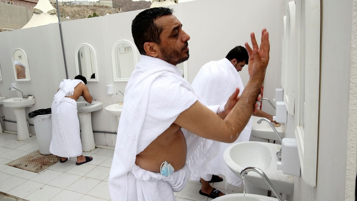 Pilgrims wash their bodies outside their tents in the Mina area during the annual Hajj pilgrimage, in Mecca, Saudi Arabia Credit: Reuters Photo