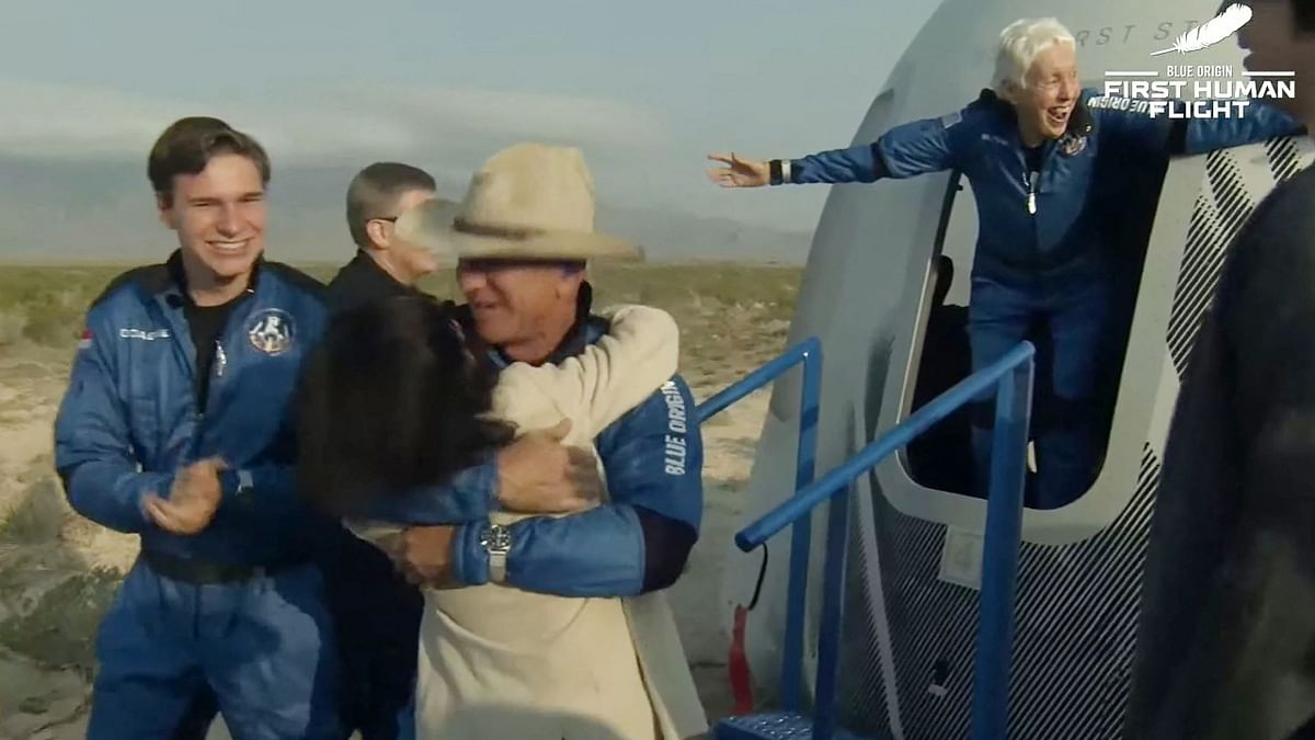 The four-member crew exchanged high-fives and hugged family who came to meet them at the landing site. Credit: AFP Photo