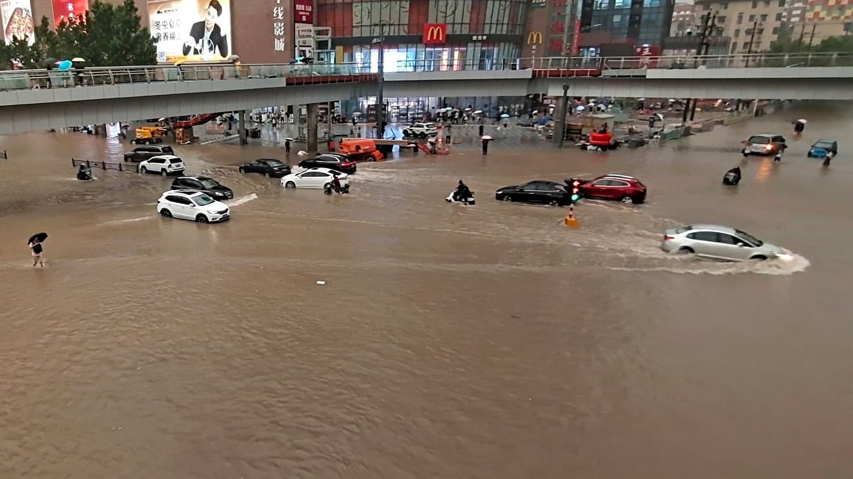 Stranded vehicles after a heavy downpour in Zhengzhou city, central China. Credit: AP Photo