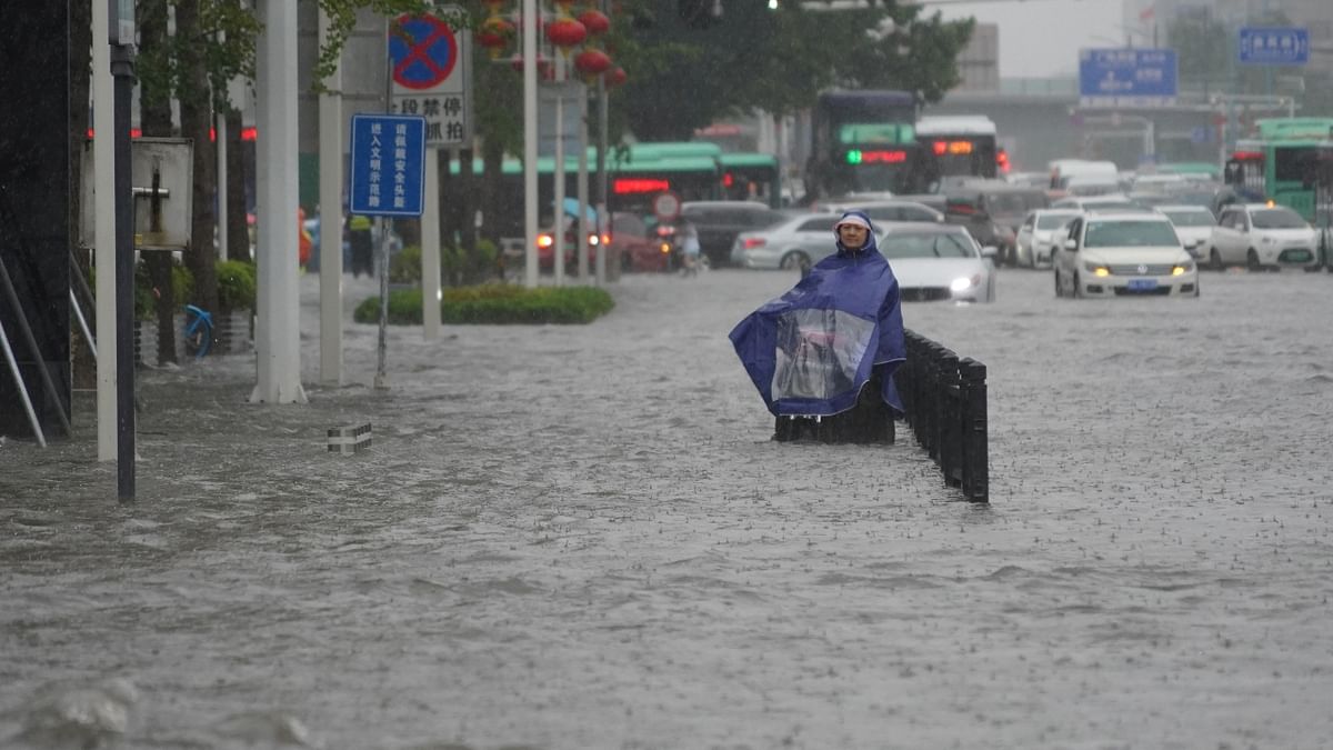 A resident is seen standing on a flooded road in Henan, Zhengzhou province, China. Credit: Reuters Photo