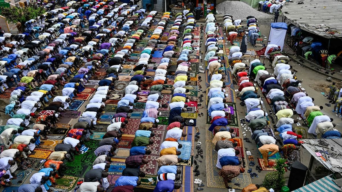 Muslims pray in the street in front of the mosque in Adjame, a popular neighbourhood of Abidjan, during the Eid al-Adha celebrations. Credit: AFP Photo