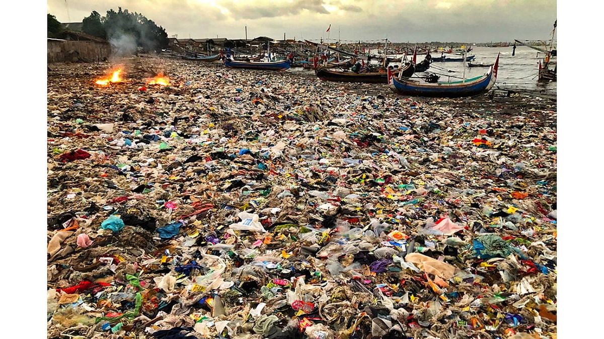 This local beach in Java, Indonesia, has become an illegal dumpsite for plastic waste. One of the residents can be seen burning the plastic, so it doesn’t enter her house at high tide. Photo by Vincent Kneefel (The Netherlands)