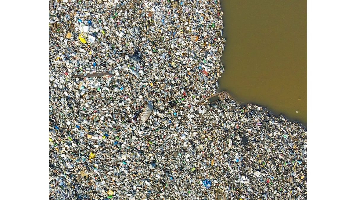 Major drainage systems in Accra, Ghana's capital city, empty single-use plastic waste into the ocean through the Korle Lagoon. The urban poor sometimes swim in it to recover recyclable material. Aerial view of the Korle Lagoon, choked with single-use plastic, Ghana. Photo by Muntaka Chasant (Ghana)