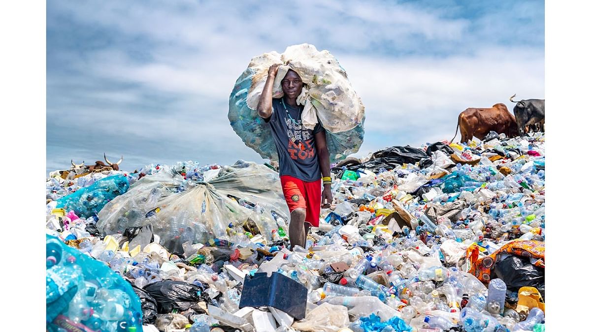 In Accra, Ghana, a plastic waste scavenger brings plastic he has recovered to a dumpsite where middlemen will buy it for recycling. Photo by Muntaka Chasant (Ghana)