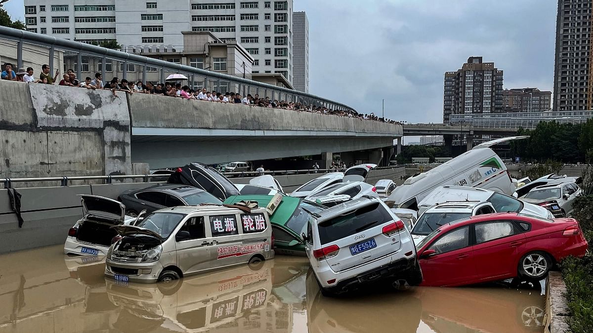 Pictures show a pile of vehicles swept away by floods, blocking a highway in Zhengzhou, China after a Historic deluge has paralyzed the city, leading to over two dozen deaths and millions of dollars in damages. Credit: AFP Photo