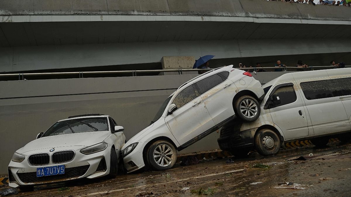 As the water retreated -- with piles of cars a monument to its deadly power -- residents prepared for another day of bad weather, moving vehicles to higher ground and trying to plot journeys out from the stricken city, where communications and power were still patchy. Credit: AFP Photo