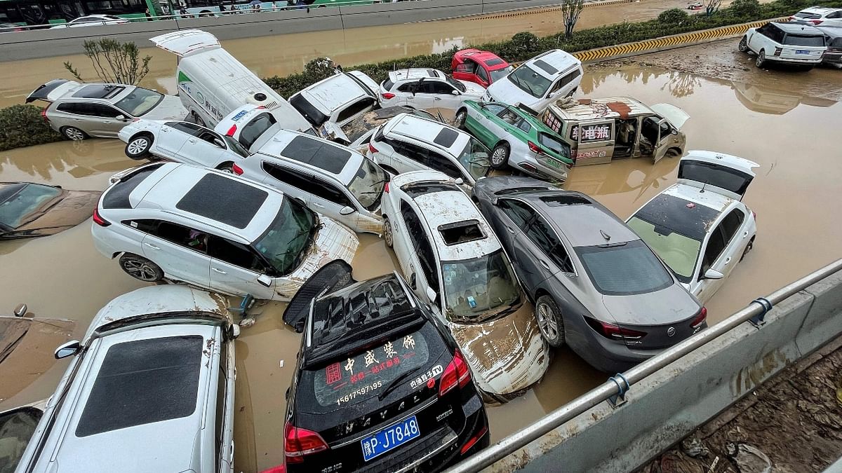 China Rains: Floodwaters wash away hundreds of cars - See Pics