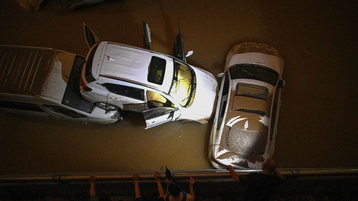 Cars submerged in flood waters at an tunnel for vehicles following heavy rains in Zhengzhou in China. Credit: AFP Photo