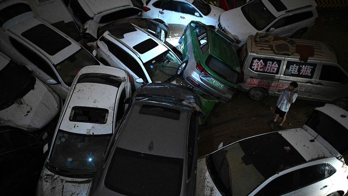 Cars stacked on each other at an entrance of a tunnel following a heavy rain in Zhengzhou in China. Credit: AFP Photo