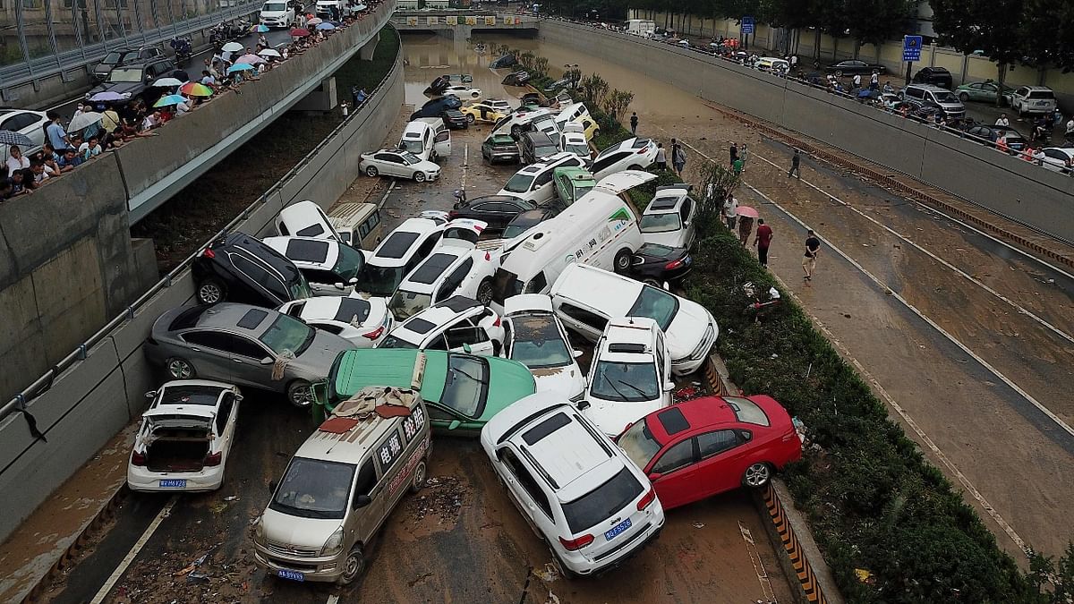 An aerial view shows cars sitting in floodwaters at the entrance of a tunnel after heavy rains hit the city of Zhengzhou, China. Credit: AFP Photo