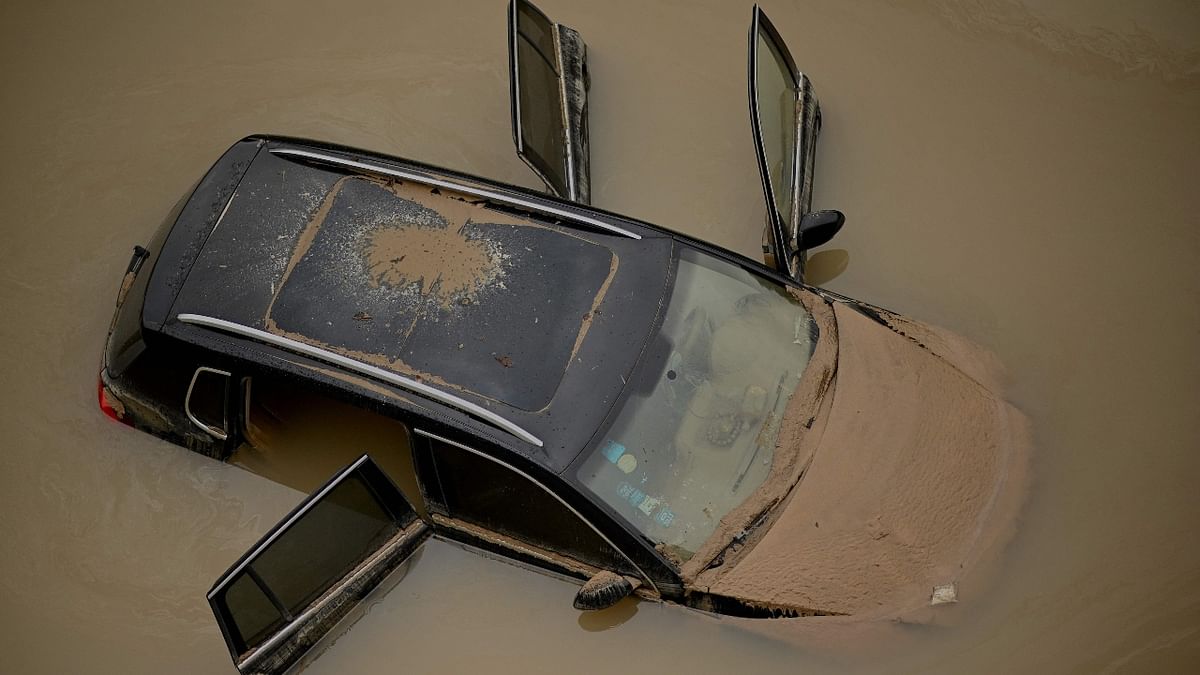 A car sits in floodwaters following heavy rains, in Zhengzhou in China. Credit: AFP Photo
