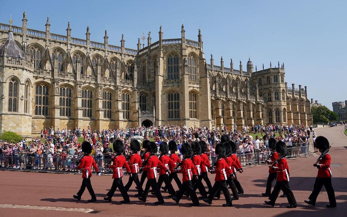 Members of the new guard of the 1st Battalion Grenadier Guards arrive before the Changing of the Guard at Windsor Castle in Berkshire, south east England, which is taking place for the first time since the start of the Covid-19 pandemic. Credit: AFP Photo