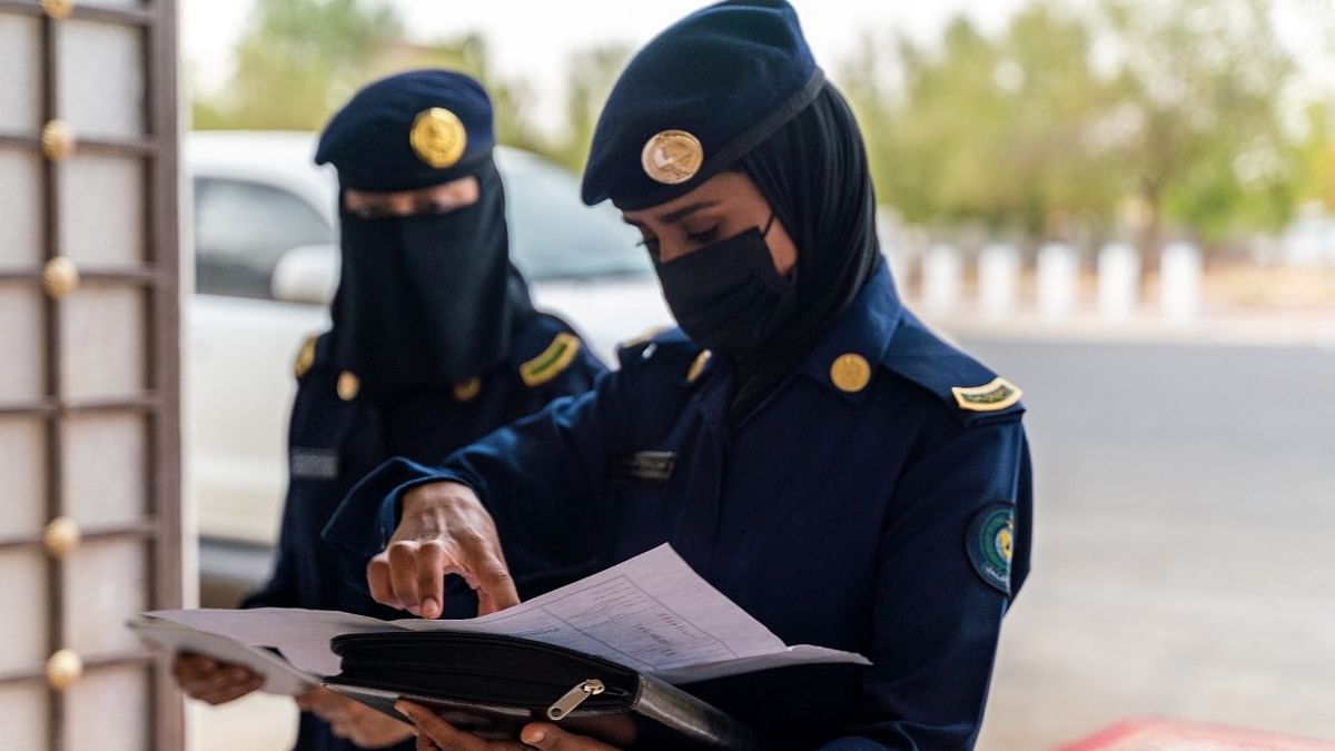 Pictured: Saudi police female officers checking documents of pilgrims as they arrive in the Grand Mosque, in the holy city of Mecca, Saudi Arabia. Credit: Reuters Photo