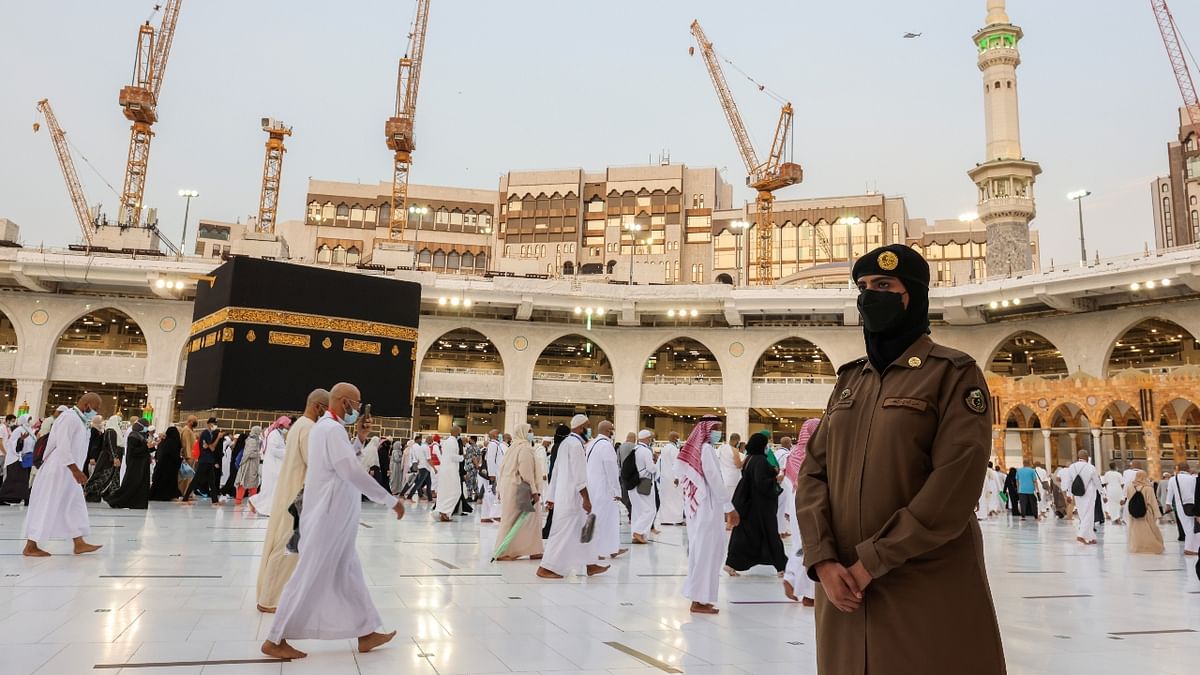 Dressed in a military khaki uniform, with a hip-length jacket, loose trousers and a black beret over a veil covering her hair, Mona spends her shifts roaming in the Grand Mosque in Mecca. Credit: Reuters Photo