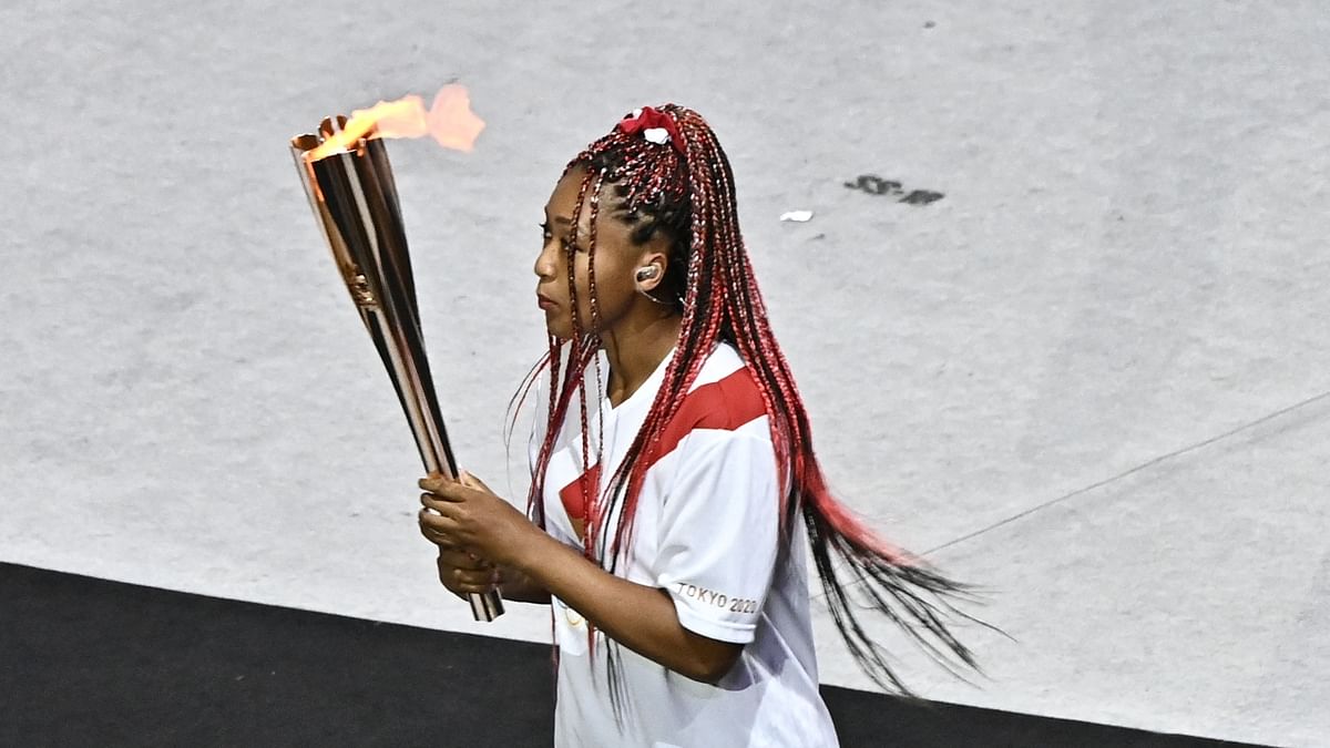 Japan's tennis player Naomi Osaka carries the Olympic torch in the Olympic Stadium during the opening ceremony of the Tokyo 2020 Olympic Games, in Tokyo. Credit: AFP Photo