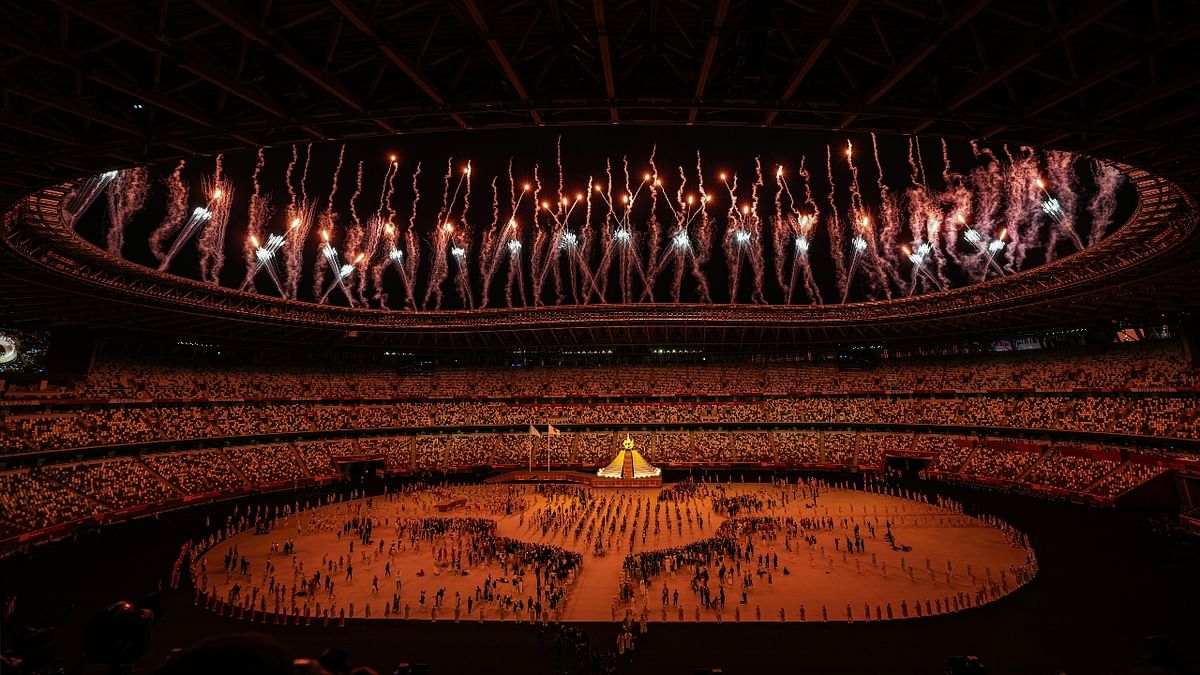 Fireworks illumine the sky after the lighting of the Olympic flame at the Olympics Stadium during the opening ceremony of the Summer Olympics 2020, in Tokyo. Credit: PTI Photo