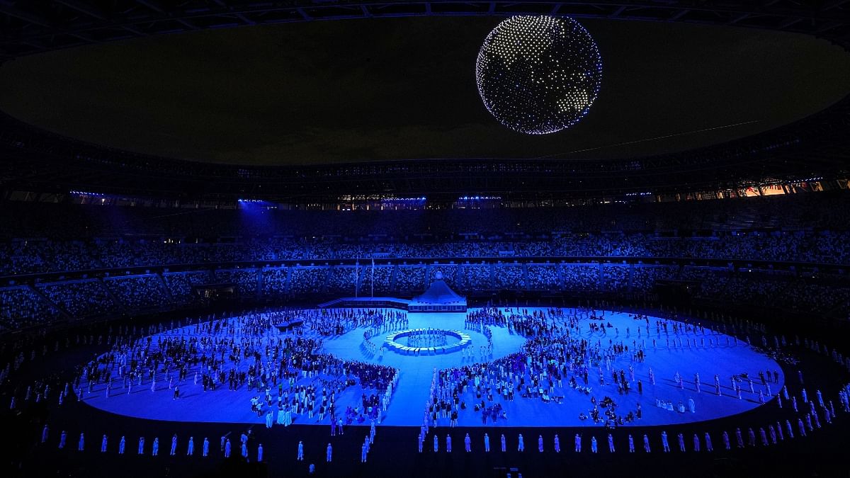 Drones with lights create 3-D patterns at the Olympics Stadium, during the opening ceremony of the Summer Olympics 2020, in Tokyo. Credit: PTI Photo
