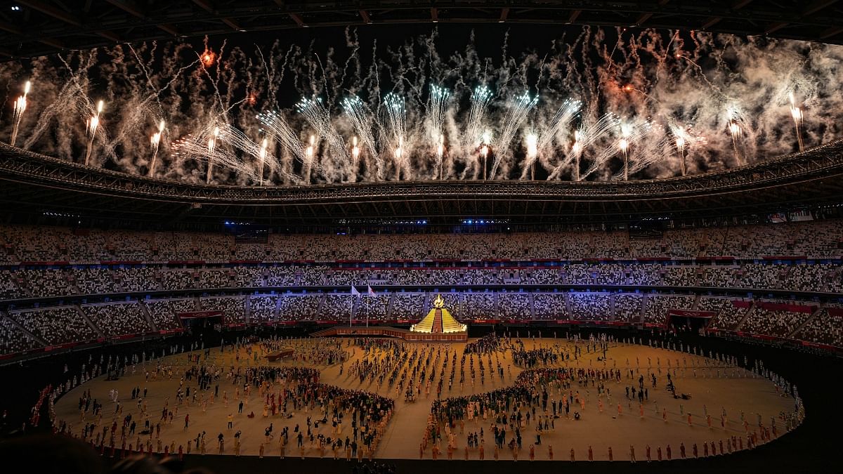 Fireworks illumine the sky after the lighting of the Olympic flame at the Olympics Stadium during the opening ceremony of the Summer Olympics 2020, in Tokyo. Credit: PTI Photo