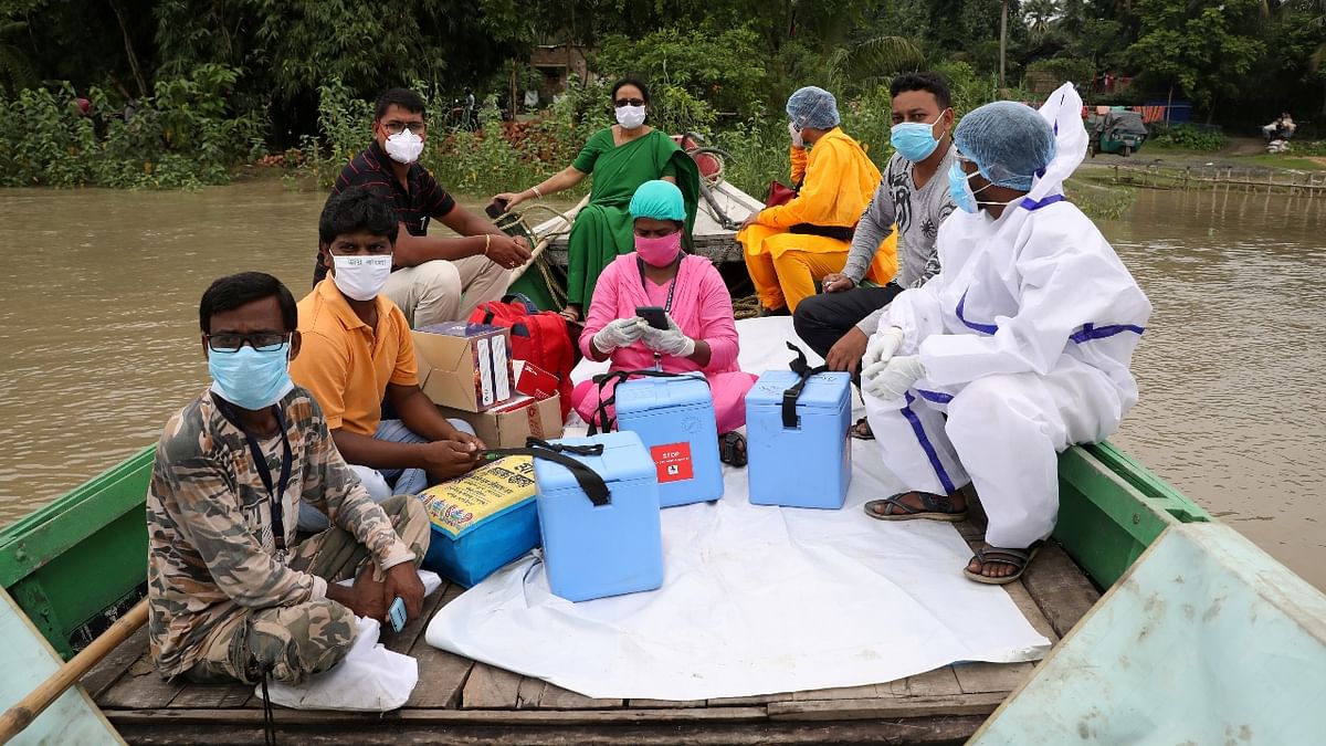 Healthcare workers cross Mundeswari river in a boat to inoculate villagers with Covishield vaccine in West Bengal. Credit: Reuters Photo